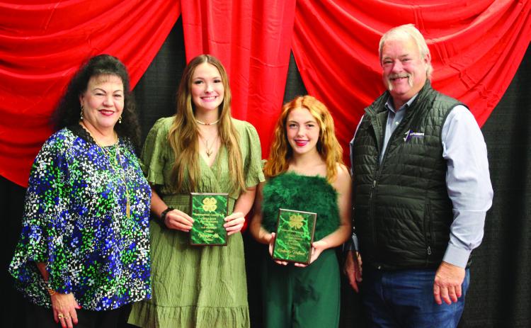 Suzanne and Randy Gilbert presented the Outstanding Senior Award to Megyn Alls and Kimberly Holland during the Pottawatomie County 4-H Awards Banquet, held at North Rock Creek High School on Oct. 21. Countywide &amp; Sun/Natasha Dunagan