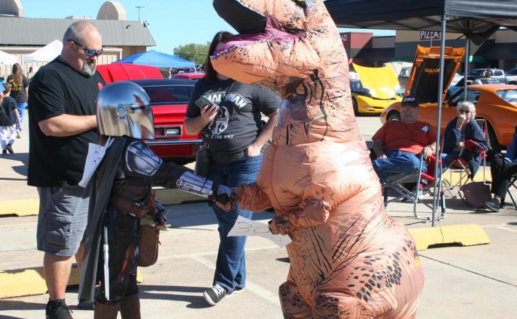 Eleven-year-old Colby Duroy (right) shakes hands with a fellow costume contest contestant dressed as the Mandalorian, while gathering for the contest. The costume contest took place at the 17th Annual FireLake Casino Car Show, Oct. 16. See more photos on page B7. Countywide &amp; Sun/Kendra Johnson