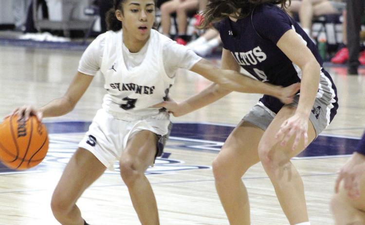 Shawnee sophomore Tarilynn Thierry guards the ball from from an Altus defender during their last regular season home game on Feb. 9. The Lady Wolves won, 59-35, and have a record of 15- 7.