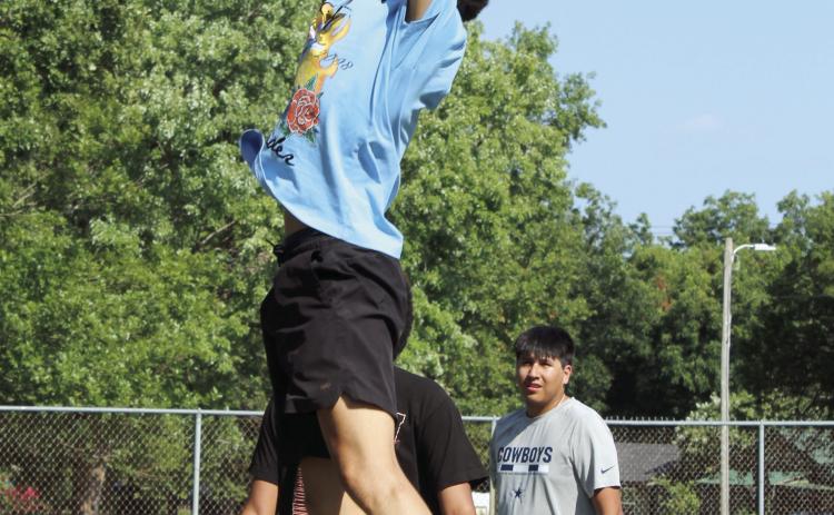 Earlsboro High School 2022 graduate Ryan Long dunks the ball, as SHS graduate Chevis Sharp, Jr. (hidden) and Bethel High School 2023 graduate Si Foreman watch, during the First Annual Hoops for Hope on July 25. Photos by Natasha Dunagan, Countywide & Sun