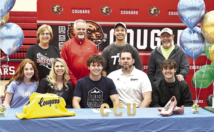 North Rock Creek's Ethan Nowakowski signs his letter of intent to run track at Colorado Christian University. Sitting is Jannah Shoffner, parents Brandi &amp; Chris and brother Zach. Standing Melanie McLaughlin, Burky Curtis, Tyree York, and Pete Nowakowski. Photo courtesy of Gowin Photography