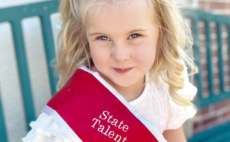 Autumn Hughes, 5, of Tecumseh, poses in her Oklahoma Tiny State Talent sash and crown on June 27. Hughes is planning to compete in the national competition, July 13-17. Countywide & Sun/Julie Talton