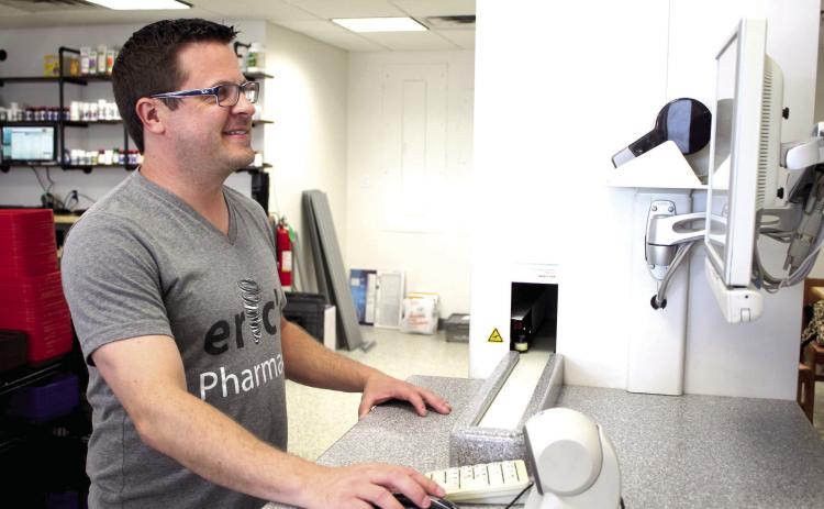 Pharmacist Jathan Coburn uses a Script Pro robot to dispense medications at the new temporary Eric’s Pharmacy location, 4151 N. Harrison in Shawnee, on June 29. Countywide &amp; Sun/ Natasha Dunagan