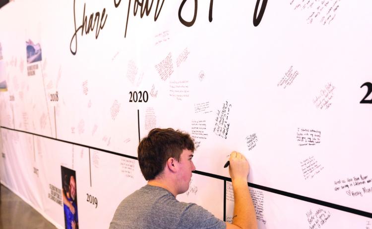 Members of Life.Church add their story to the 10 year4 timeline wall during the anniversary celebration. Photo provided