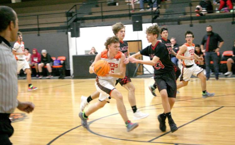 Wanette Tigers’ Zane Hulce (#15), evades the Eagles defenses during Wanette’s Friday night win over Victory Life Academy. The Tigers won 60-33. Countywide &amp; Sun/Kendra Johnson