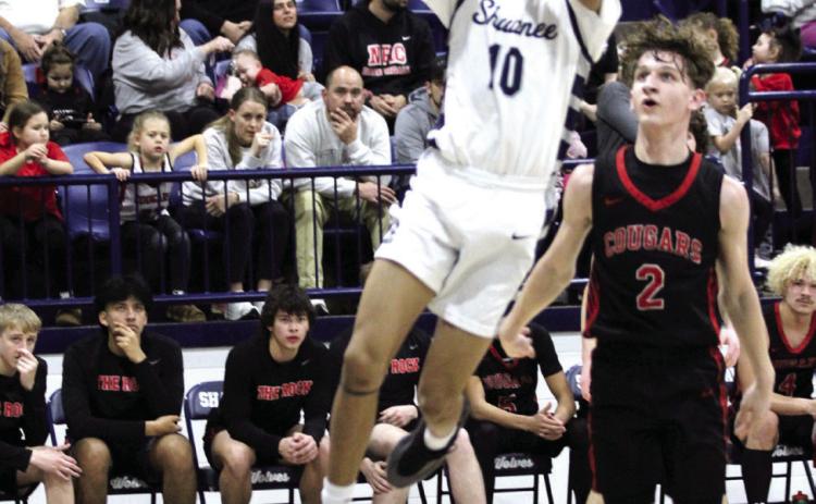 Shawnee senior Zyron Campbell makes a bucket as North Rock Creek junior Kohen Warden looks on during the Feb. 8 game at Shawnee. The Wolves lost, 53-61. Countywide & Sun/Natasha Dunagan