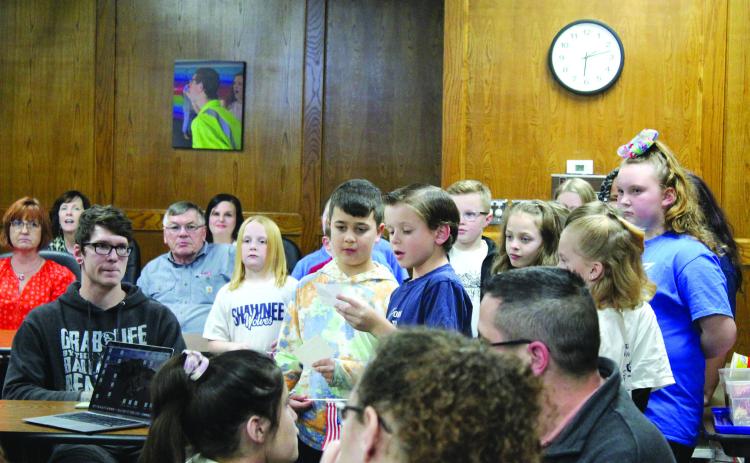 Joshua Ruiz and Carson Hutchcraft, two Sequoyah Elementary third-grade students, tell about the song “You’re a Grand Old Flag” before singing it at the Jan. 9 Shawnee Board of Education meeting. They were led by Music Teacher Jana Stelzer. In recognition of Sequoyah Elementary, Principal Kim Paxson introduced fourth-grader Reece Turner who led the flag salute. Countywide &amp; Sun/Natasha Dunagan