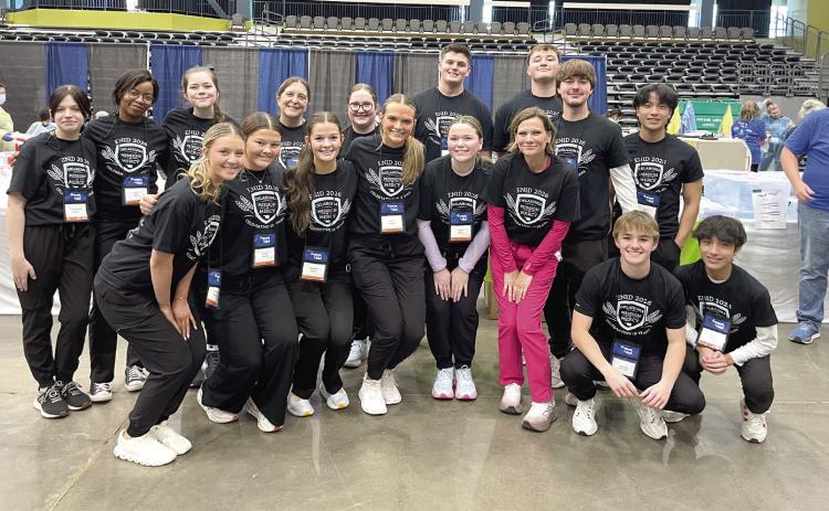 North Rock Creek High School students, along with sponsors, Kristin Grimes, Spanish teacher, and Brandy Smith, Biological Science and Health Careers Teacher stop for a group photo after volunteering at the OkMOM event held in Enid this year. Photo Provided