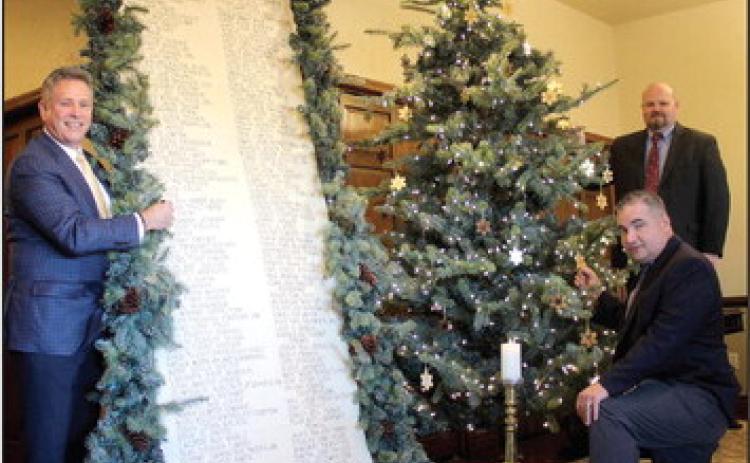 J. Cooper, Don Henson, and Landon Qualls pose with the Scroll of Honor and the Christmas Tree of Remembrance at Cooper Funeral Home in Tecumseh. Cooper Funeral Home will present “A Christmas Keepsake” program in the chapel for the 31st year on Dec. 4 at 2 pm. The families of those served by Cooper this year are invited to attend.