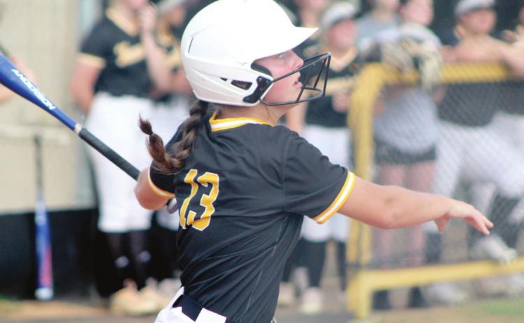 Tecumseh junior Taylor Gage hits a triple in the fourth inning of the Class 5A District slowpitch game against Bethel on April 21 at Tecumseh. During the double header, the Lady Savages won both games, 10-0, to become the district champions. Countywide &amp; Sun/Natasha Dunagan