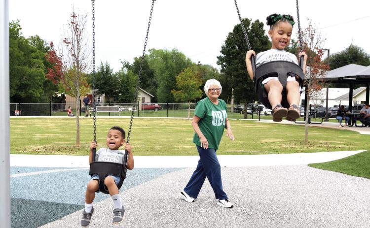 Cyndi Hanft pushes her 4-year-old twin grandchildren, Jaxson and Willow Gaines during OBU Fan Day at KidSpace Park on Aug. 30. _e temperature was almost 20 degrees cooler than last year's event and the turnout was great. Photos by Julie Talton, Countywide &amp; Sun