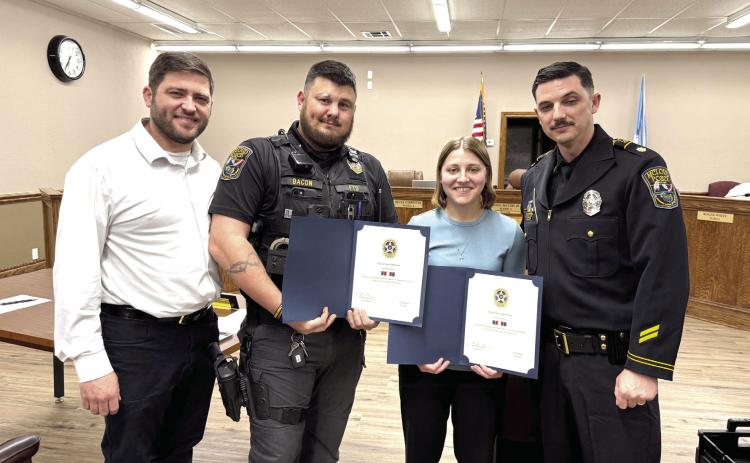McLoud Mayor Daniel McClure (left) and Major Alan Pinette (right) pose with Sgt. Chris Bacon and Officer Taylor Swanson. Bacon and Swanson were both given commendations for providing life saving treatment to citizens last month, on separate occasions. Julie Talton, Countywide &amp; Sun