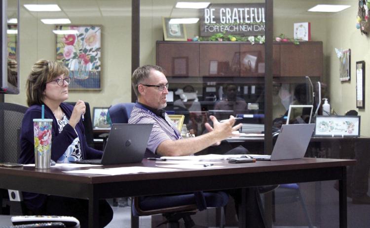 Minutes Clerk Denise Flowers listens as Bethel Public Schools Superintendent Dr. Matt Posey speaks to the Bethel Board of Education at their Aug. 14 meeting. Countywide & Sun/Natasha Dunagan