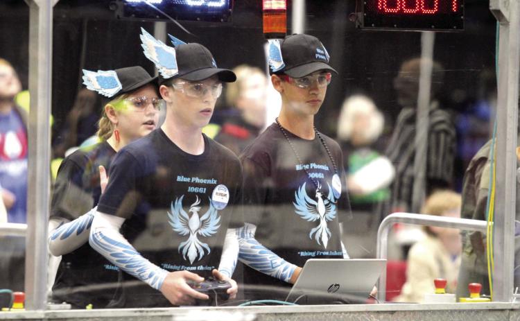 Grove School eighth-graders Emma Knight, Conner Vorndran and Daniel Bowlan watch over and control their robot, Sapphira, during the Oklahoma Regionals FIRST Robotics Competition, held at FireLake Arena on April 5. They are members of the new community robotics team called Blue Phoenix, which is housed at OBU and led by Lori Farris, a teacher at Grove. Natasha Dunagan, Countywide & Sun