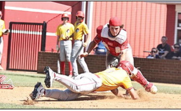 North Rock Creek's Greyson Ratcliff stops the Dale runner for the out at home. It was a clean sweep for Dale as the Cougars lost the varsity game 3-4 and the JV lost 2-8. Photo courtesy of Gowin Photography