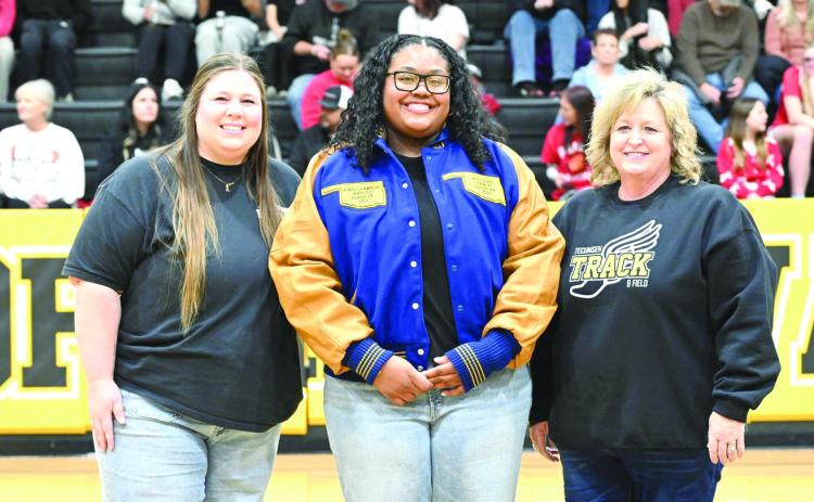 Tecumseh High School 2025 graduate Kiara Stallin received her All-State Track jacket during the homecoming games on Jan. 30. Also shown are former track coach Montana Palmer, left, and Track and Cross-Country Coach Kortney Ozment. Photo courtesy of Kenetta Lisenbee
