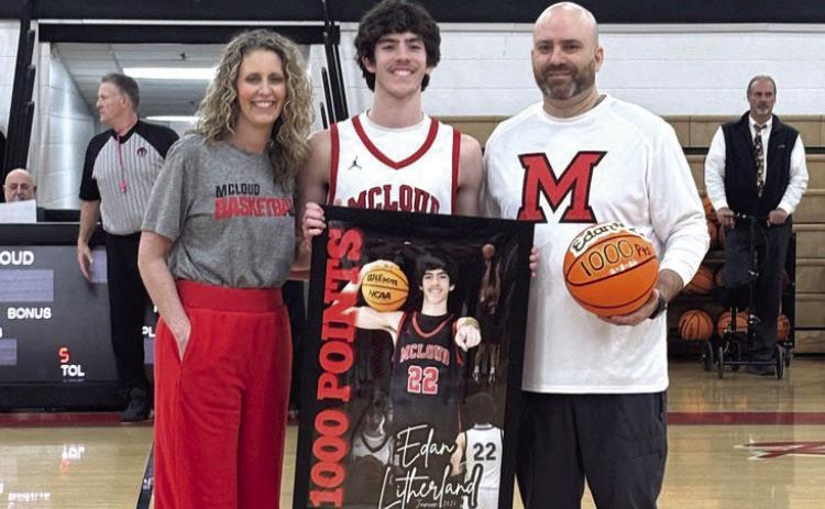 McLoud junior Edan Litherland poses with his parents, Stephanie and Eric Litherland, who are presenting him with his 1,000 Points banner and game ball on Feb. 6. The younger E. Litherland reached 1,001 high school career points during the Feb. 3 game at Tecumseh, where he contributed 34 points. The elder E. Litherland is McLoud's Head Boys Basketball Coach and Athletic Director and also celebrated his 200th win as a coach on Feb. 6. Natasha Dunagan, Countywide &amp; Sun