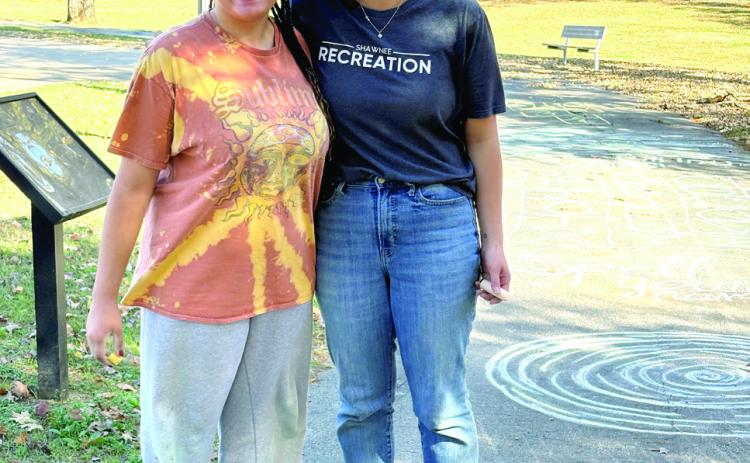 The Fall Youth Volunteer Program completed a sidewalk chalk obstacle course. This project was completed by youth volunteer Savannah Talton (left), who clocked in 28 hours during the fall program and Recreation Aide, Shaylee Crowder. Photo Provided