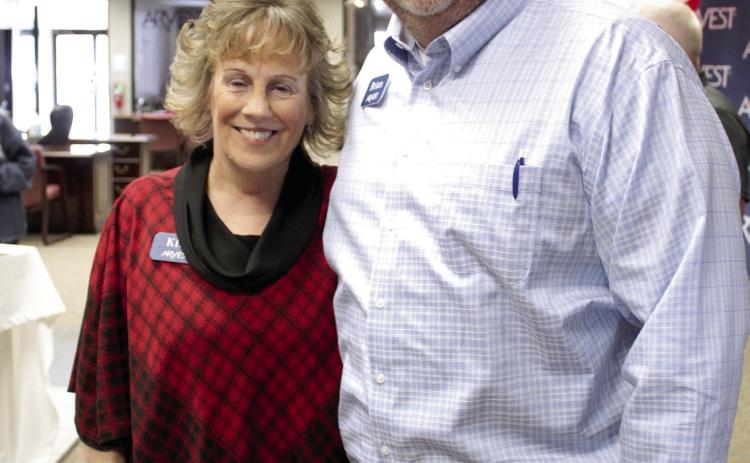Kim Rawls poses with Arvest Community Bank President Brian Nave during her retirement reception on Dec. 30. Rawls worked for the bank for 43 years. Countywide &amp; Sun/Natasha Dunagan