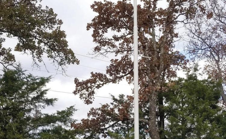 A bugler from OBU and the VFW Post 1317 Honor Guard pose at the Brown Cemetery Veterans Memorial during a dedication ceremony on Nov. 11. The memorial includes a wall, 32-foot flag pole with the five military brances plaque, bench and “Freedom Isn’t Free” metal sign. It was spearheaded by Karen Hilditch and her brother Bobby Cearley who are now planning to place 122 wreaths on veterans graves at the cemetery, six miles west of Tecumseh. Photo provided.