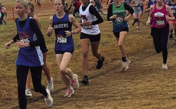 Earlsboro Junior Aha Roubidoux (white jersey) runs in the State Cross Country Track Meet hosted by North Rock Creek on Oct. 25. Photo Provided