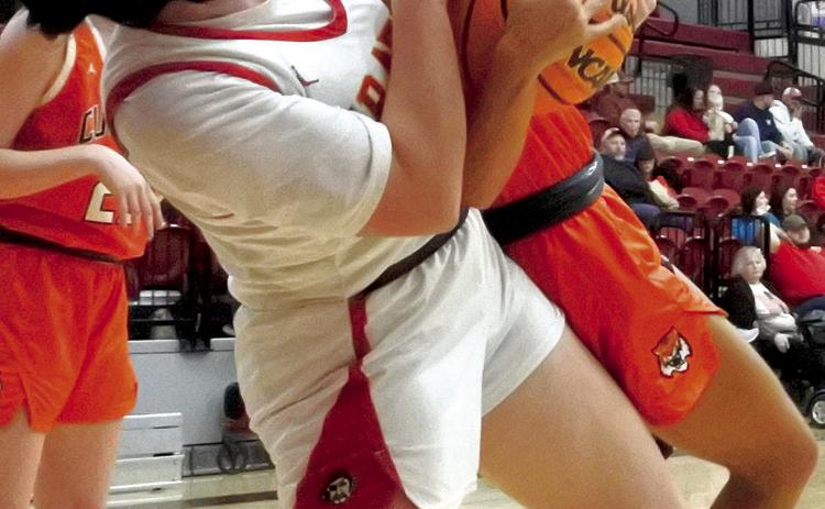 Dale Lady Pirate Karsen Griggs lifts her Cushing opponent off the ground as she tries to rip the ball loose, but ends up with a jump ball during the game Thursday, Dec. 7. The Lady Pirates won the first round game of the Boomarang Classic Tournament, 56-21. Countywide &amp; Sun/Suzie Campbell