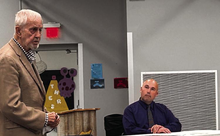Donald Rominger (left) addresses the board while Superintendent Robert Kinsey listens intently Countywide &amp; Sun/Suzie Campbell