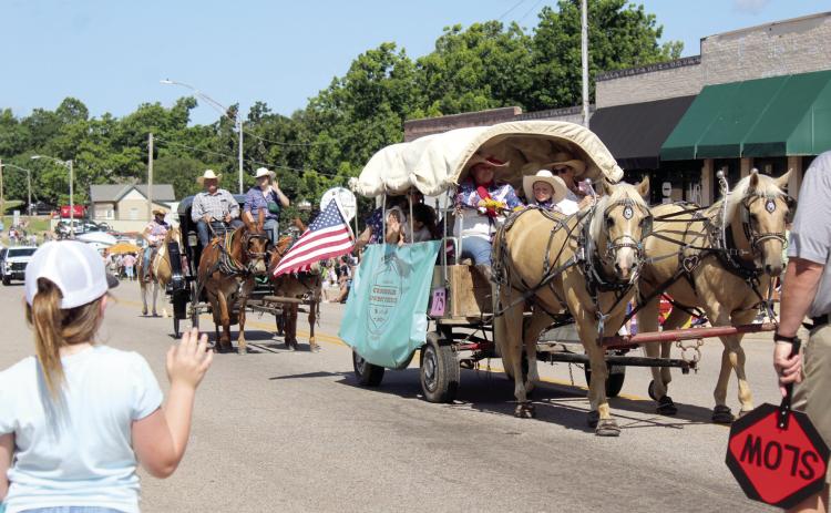 A covered wagon and a carriage from Crossroads Cowboy Church in Harrah make their way east on Broadway Ave. during the McLoud Blackberry Festival Parade on June 21. There were 75-80 entries in the parade, said Melanie Krause with the McLoud Chamber of Commerce.