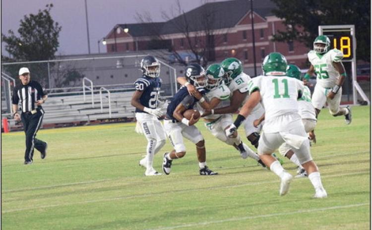 Shawnee Quarterback, junior Jamir Owens, gets wrapped up in a tackle by the Seminole Chieftains.. Countywide & Sun/Julie Talton
