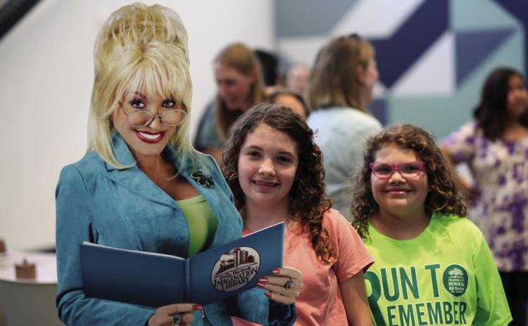 Library customers pose to celebrate Dolly Parton’s Imagination Library. (Photo provided.)