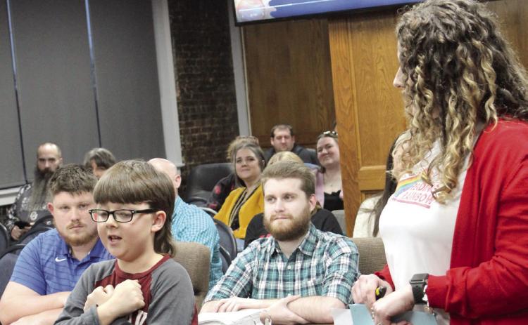 Shawnee third-grader Ben Wilson recites and performs the motions to the Horace Mann Elementary Mission Statement, with the help of Principal Christi Lovelady, during the March 3 Shawnee Public Schools Board of Education meeting. Natasha Dunagan, Countywide & Sun