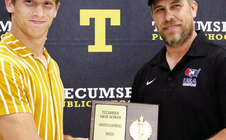 Tecumseh Head Wrestling Coach Billy Don Sigman, right, presents the Outstanding Male Athlete Award to Jace Frazier during the THS Athletic Awards on May 15. Sigman said Frazier is a three-time state qualifier in wrestling and conference champion. Countywide & Sun/Natasha Dunagan