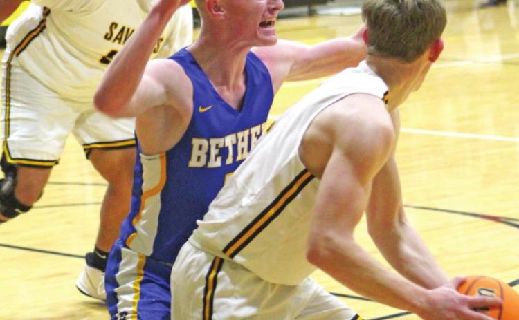 Tecumseh’s Ben Corley looks to pass the ball to his teammate Jay Mitchell as Bethel’s Jace Stewart plays defense. Countywide &amp; Sun/ Natasha Dunagan