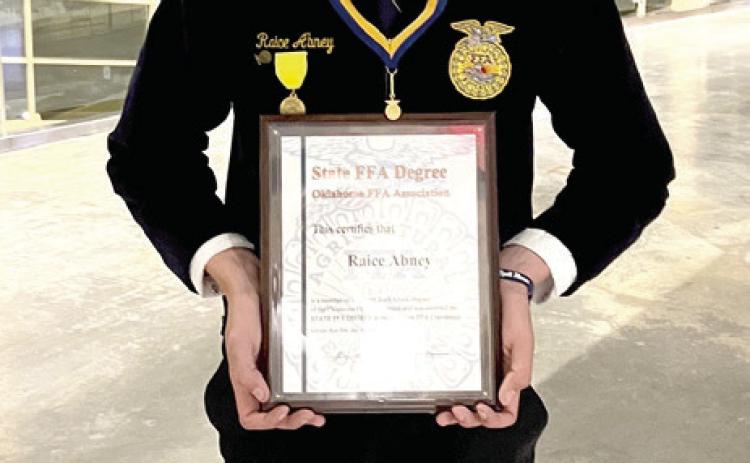 North Rock Creek graduate Raice Abney recently received his American FFA Degree. He is shown holding his State FFA Degree, which is a prerequisite, in 2024. Photo provided