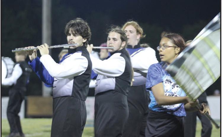 Pride of Bethel band members Cayden Ricker, Nathan Ricker, and Elijah Robertson perform music from the Blues Brothers, as color guard member Patience Steli dances around them with her flag, during the Sept. 6 football game halftime. File photo