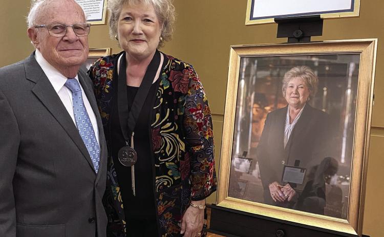 Melvin Moran (left) congratulates Lana Reynolds (right) as they stand next to her portrait. Portraits of each honoree were unveiled at the reception and will remain on display at the Oklahoma History Center until being moved to the Oklahoma State Capitol in January. The exhibit will then travel to several locations around the State. A complete listing of the award recipients is available at: www/55over55.com/winners. Photo provided