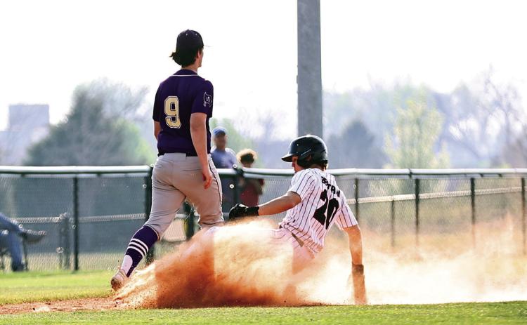 North Rock Creek's Hunter Bertram slides safely into third base. The NRC baseball team beat Mannford, 8-3, in a district game Tuesday, Mar. 25, 2025. Photo courtesy of Gowin Photography