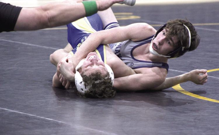 Shawnee’s Blayne Taber gets confirmation from the referee of the pin of his Noble opponent during the dual meet on Jan. 25, held at the PAAC. File photo