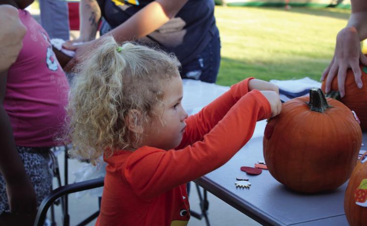 Emery Thomas, 2, of Bethel, decorates a pumpkin with stickers during the Frenzy on Federal Oct. 1. Countywide &amp; Sun/Natasha Dunagan