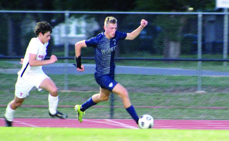 Shawnee’s Camden Sateren drives toward the goal during the home game against Bishop Kelley on April 14. The Wolves lost, 0-5. Countywide &amp; Sun/Natasha Dunagan