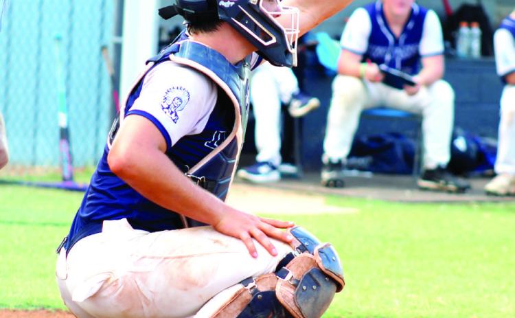 Asher sophomore Mitchell Skender snatches the ball from above as catcher during the third inning of the Aug. 25 home game.
