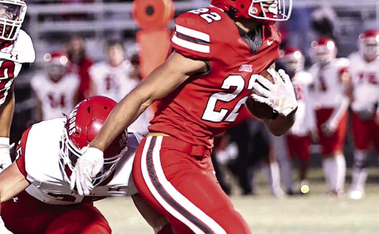 North Rock Creek's Caleb Hawkins rushes past the defense on his way to his first touchdown of the evening in a 2024 NRC regular season game. Photo courtesy of Gowin Photography