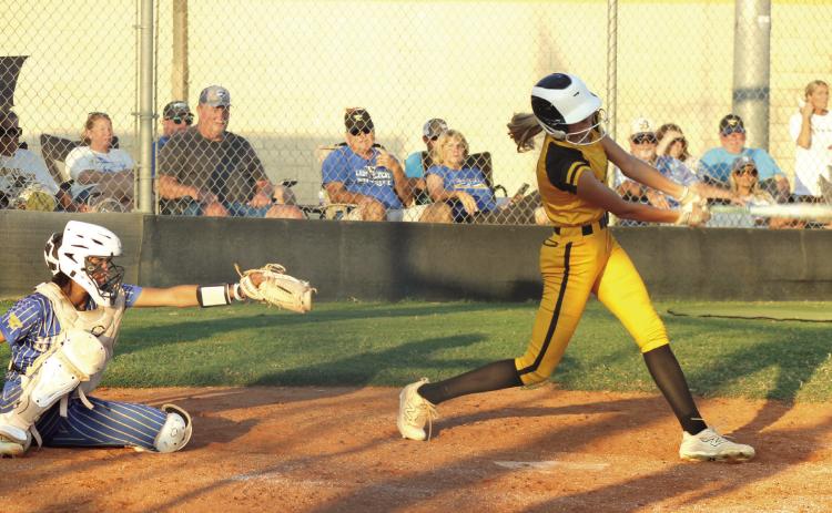 Tecumseh senior Haley Mansell gets a hit before taking a walk, as Bethel senior Layla Menhusen reaches for the catch, during the game at Tecumseh on Sept. 23. Natasha Dunagan, Countywide &amp; Sun
