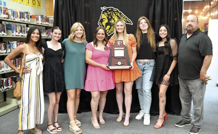 Tecumseh Slow Pitch Assistant Coach Kayla Rodriguez, Lady Savage seniors Chloe Stephenson, Laney Sanders, Khylei Daniels, Sami Schweighardt, Reagan Berry and Serenity Jacoway and Head Coach Perry Wilson pose with their Class 5A Slow Pitch State Championship trophy during the Tecumseh High School Athletic Awards on May 13. Photo provided by Kenetta Lisenbee.