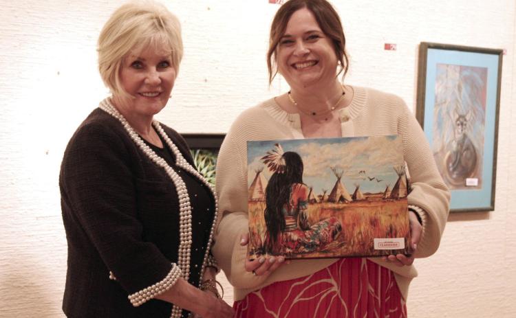 Artist Marcia Crook poses with Amanda Johnson, after Johnson chose her artwork, at the annual "Off the Wall" event at the Mabee-Gerrer Museum of Art on April 24. See full cutline below.