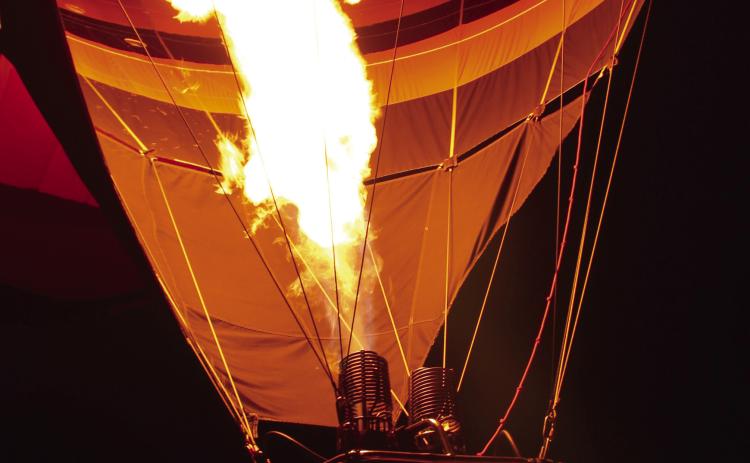 "MilkyWay," owned by Bill and Tiffany Kinser of Guthrie, is lit up during the balloon glow on Saturday, Aug. 8, at the FireLake Fireflight Balloon Festival. According to www.planoballoonfest.org, hot-air balloons use liquid propane gas in their burner systems, which shoot out a six- to eight-foot flame and produce up to 12 million BTUs per hour. The website also mentioned that the "envelope" (balloon) is made from rip-stop, flame-resistant nylon. Natasha Dunagan, Countywide & Sun