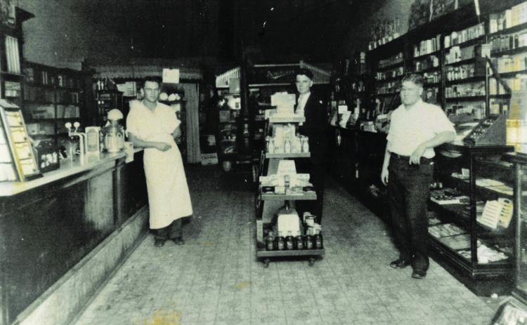 Inside Lisle Drug, approximately 1917, A.C. Lisle, Sr. (center) poses with a couple of friends. Photo provided by McLoud Historical Society