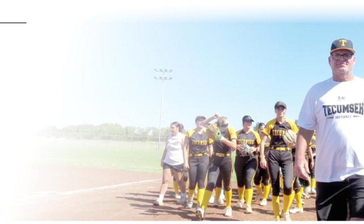 TPS Fastpitch Softball Coach Chad Trahan will be inducted into to the Oklahoma Coaches Association Hall of Fame this summer. Pictured above is Trahan with the Lady Savages team behind him. Photo provided