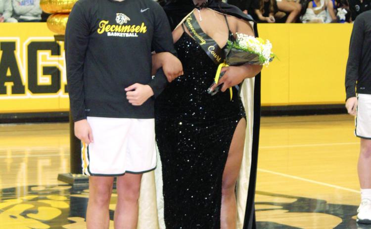 Queen Kiara Stallin is escorted by junior Sampson Martin after being crowned during the Tecumseh High School Spring Homecoming on Feb. 7.