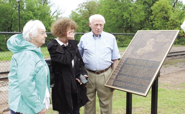 Former Vietnam POW Danny Glenn, originally of Shawnee, and his sisters, Kay and Jane, look over a bronze plaque which was dedicated to him at the Paul and Ann Milburn Center on May 4. His fellow 1957 Shawnee graduate, Walter Coffey started the ball rolling on the plaque six years ago. Countywide & Sun/Natasha Dunagan